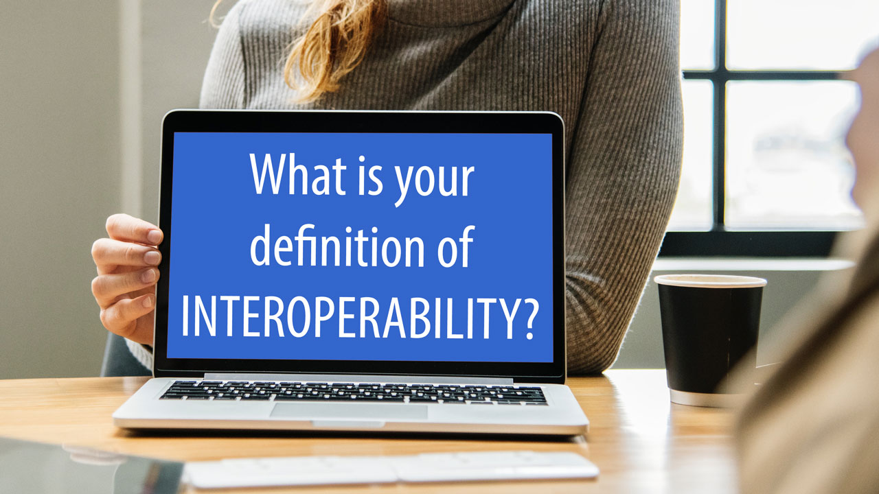 Image of a laptop with the question 'What is your definition of INTEROPERABILITY?'. 
